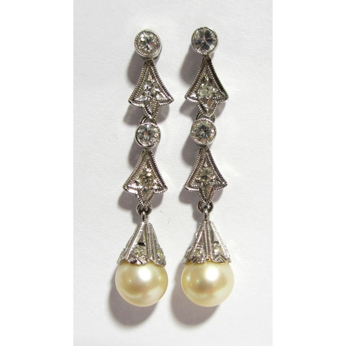 102 - A pair of cultured pearl and diamond pendant earrings