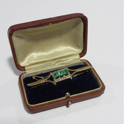 107 - An emerald and diamond brooch