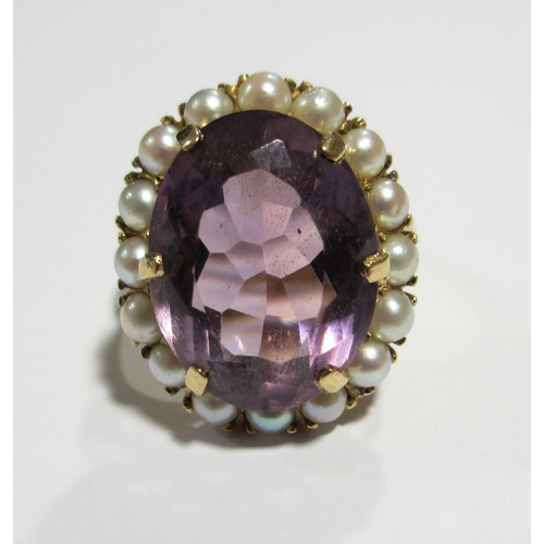 119 - An attractive amethyst and pearl dress ring