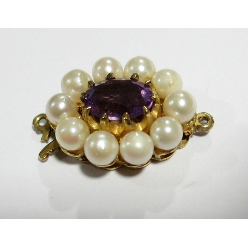 119 - An attractive amethyst and pearl dress ring