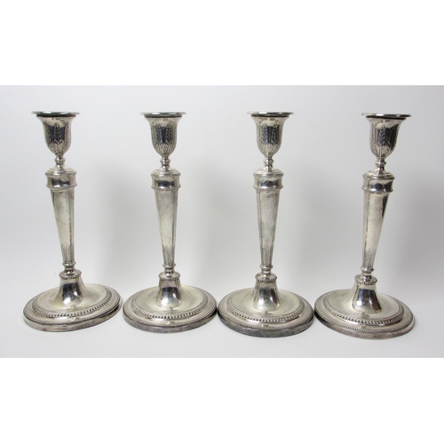 130 - A set of four George V silver candlesticks