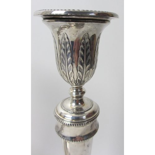 130 - A set of four George V silver candlesticks