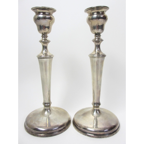 134 - A pair of George V silver candlesticks