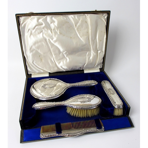 165 - A cased four piece silver dressing table set