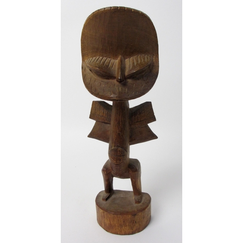 229 - A East African wood carving of a bird like figure