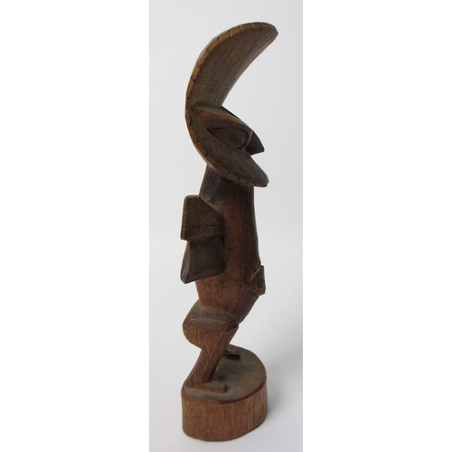 229 - A East African wood carving of a bird like figure