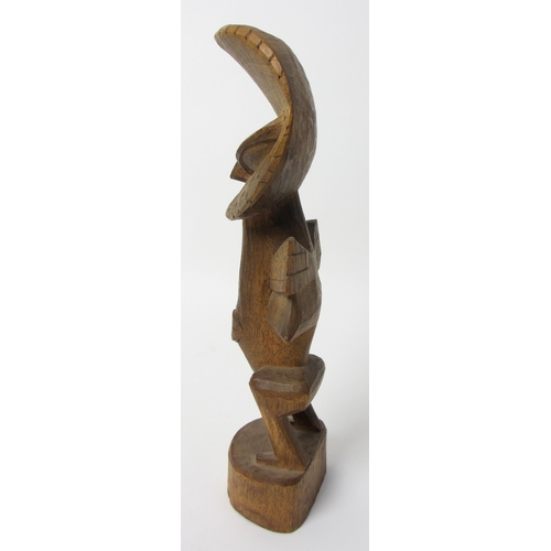 229 - A East African wood carving of a bird like figure