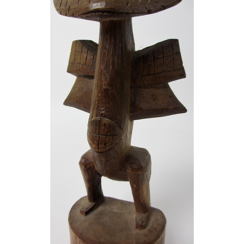 229 - A East African wood carving of a bird like figure