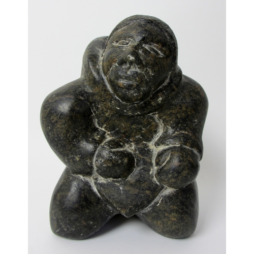 231 - An Inuit steatite / soapstone carving of a kneeling figure