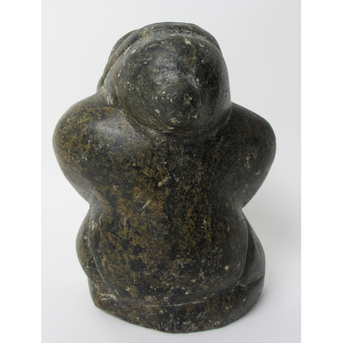 231 - An Inuit steatite / soapstone carving of a kneeling figure