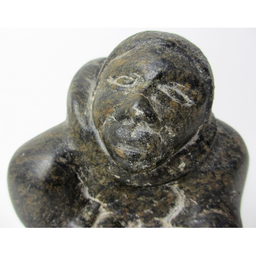 231 - An Inuit steatite / soapstone carving of a kneeling figure