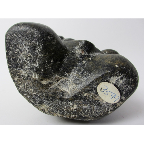 231 - An Inuit steatite / soapstone carving of a kneeling figure