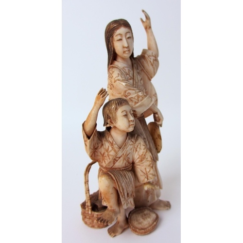 252 - A Japanese ivory group of a mother and child