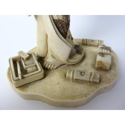 254 - A Japanese carved ivory figure of a scholar