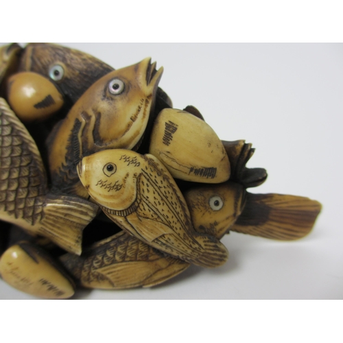 271 - A Japanese carved ivory model of numerous fish and scallops