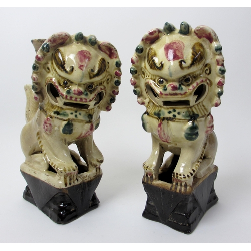 275 - A pair of Chinese pottery dogs of fo incense holders