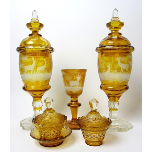 483 - A pair of Bohemian amber and engraved glass covered vases