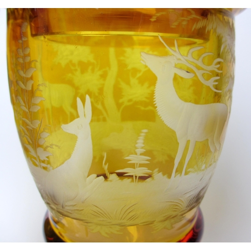 483 - A pair of Bohemian amber and engraved glass covered vases