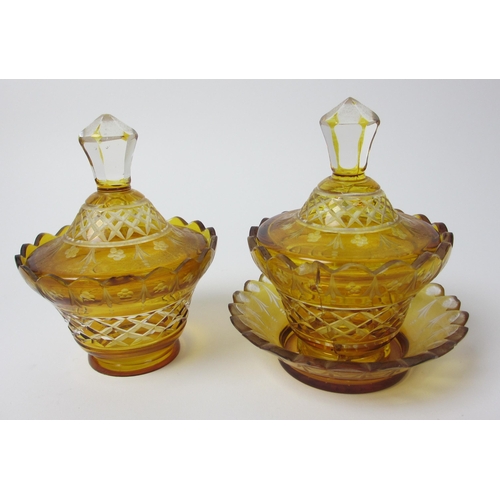 483 - A pair of Bohemian amber and engraved glass covered vases