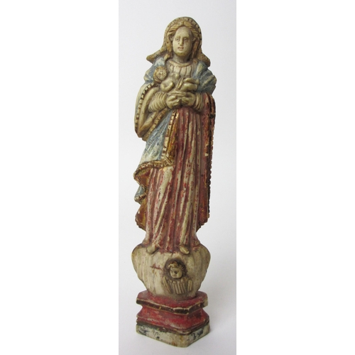 510 - A painted ivory figure of the Madonna and Child