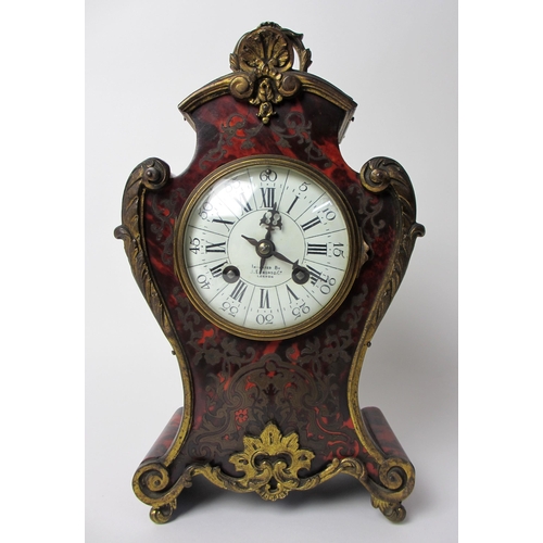 515 - A French boulle style rococo scroll shaped mantel clock