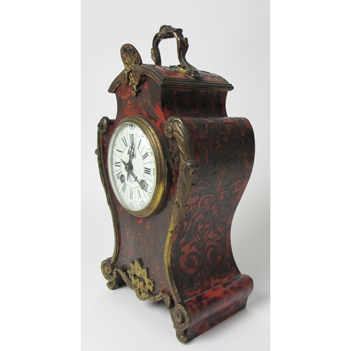 515 - A French boulle style rococo scroll shaped mantel clock