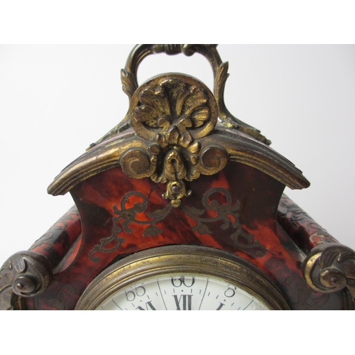 515 - A French boulle style rococo scroll shaped mantel clock