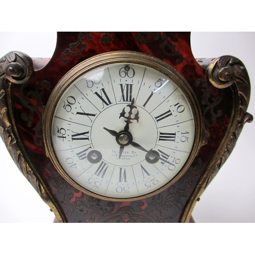 515 - A French boulle style rococo scroll shaped mantel clock