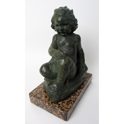 547 - A cast and painted sculpture of a young child seated on a rock