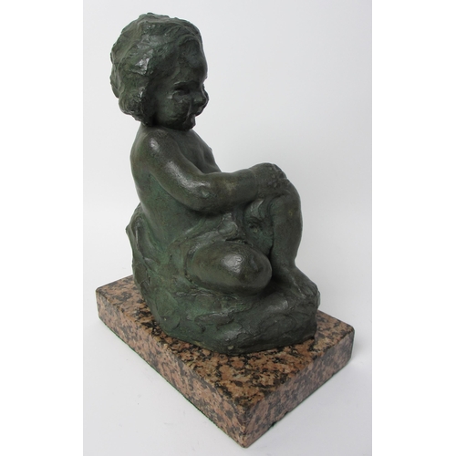 547 - A cast and painted sculpture of a young child seated on a rock