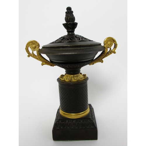 559 - A bronze and gilt metal two handled incense burner and cover