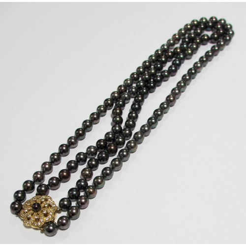 57 - A cultured black pearl and diamond necklace