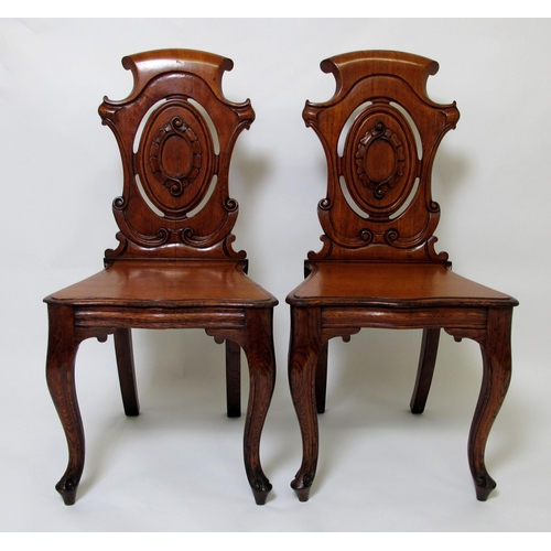 641 - A pair of Victorian oak hall chairs