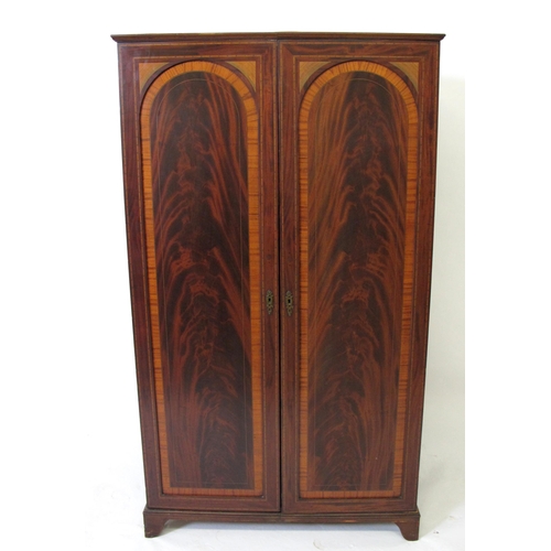 644 - An Edwardian mahogany inlaid linen press in the Sheraton style