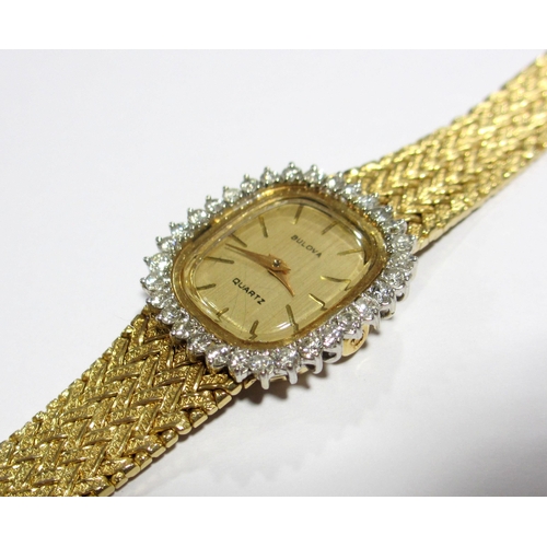 70 - A ladies 14kt gold diamond wrist watch by Bulova