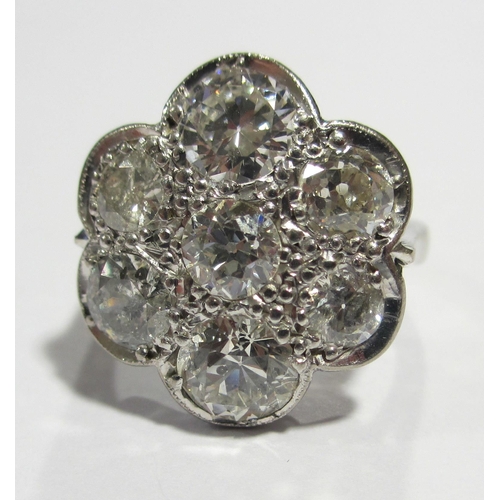 81 - A large daisy head diamond cluster ring