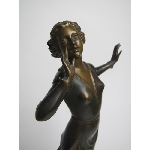 561 - An Art Deco painted spelter figure of a young woman