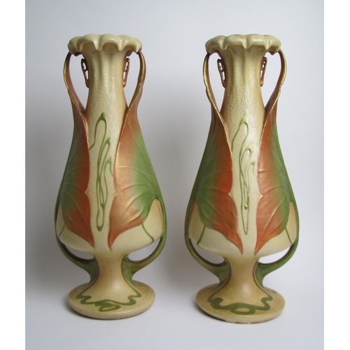 579 - A pair of Amphora Pottery lily leaf moulded two handled vases