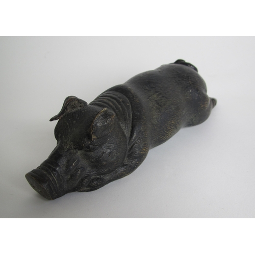 587A - A bronze model of a recumbent pig