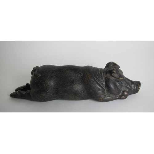 587A - A bronze model of a recumbent pig