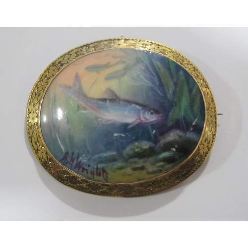 61 - A Victorian hand painted oval porcelain brooch depicting fish under water