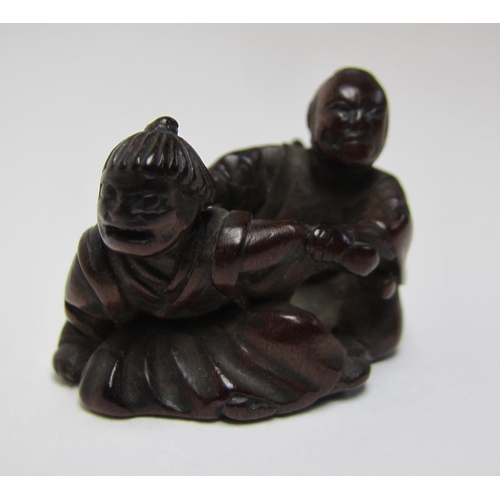 654 - A Japanese carved wood netsuke of two figures