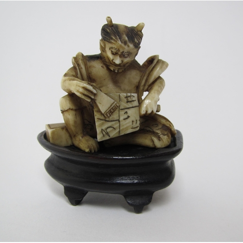 657 - A Japanese carved ivory oni