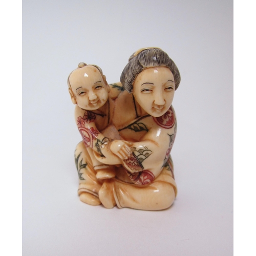 660 - A Japanese ivory netsuke of a woman and child