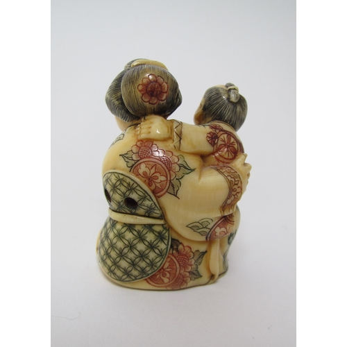 660 - A Japanese ivory netsuke of a woman and child