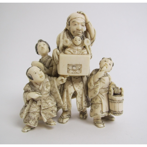 672 - A Japanese ivory okimono family group