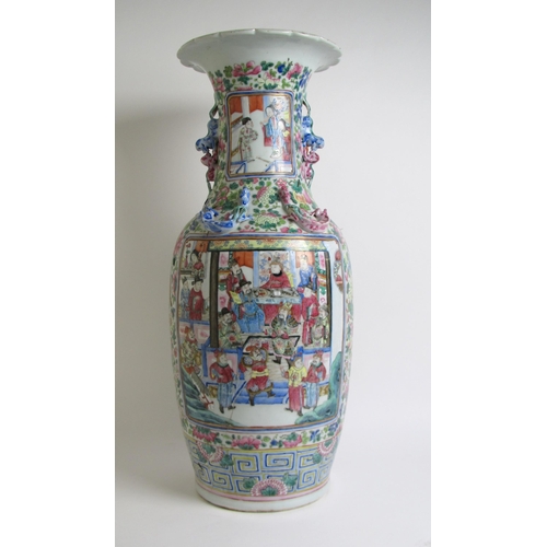 683 - A Cantonese famille rose vase painted with panels of figures