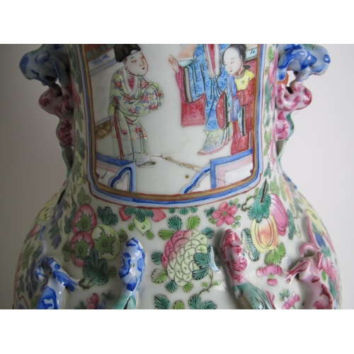 683 - A Cantonese famille rose vase painted with panels of figures