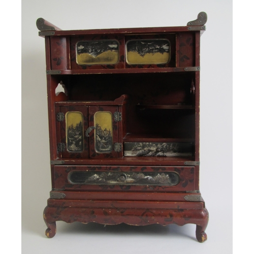 691 - A Japanese red lacquer table cabinet