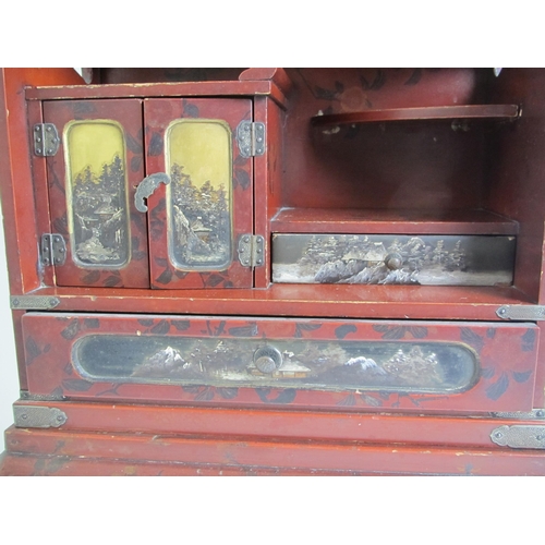 691 - A Japanese red lacquer table cabinet